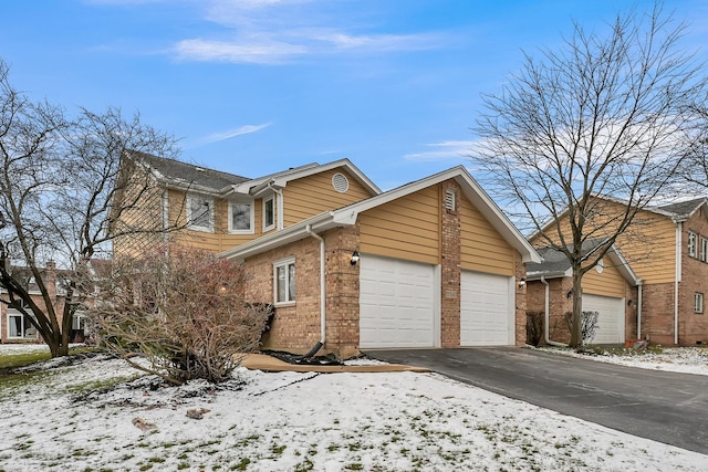 view of snowy exterior with a garage