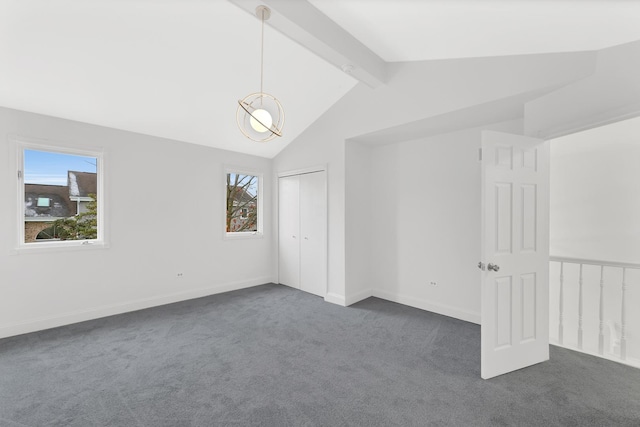 interior space with lofted ceiling with beams and dark carpet