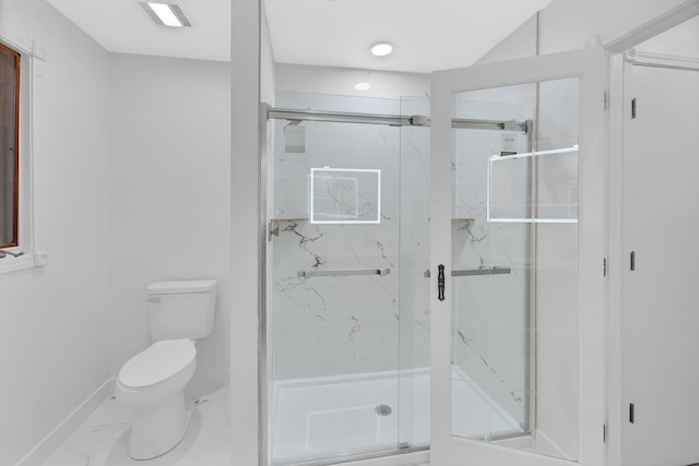 bathroom featuring toilet and a shower with shower door