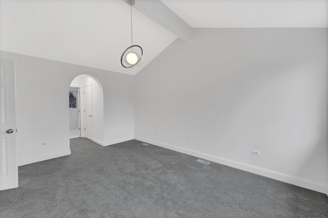 empty room featuring vaulted ceiling with beams and dark colored carpet