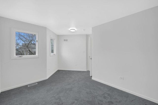 empty room with dark colored carpet