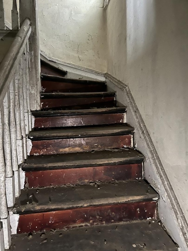 stairway featuring concrete floors