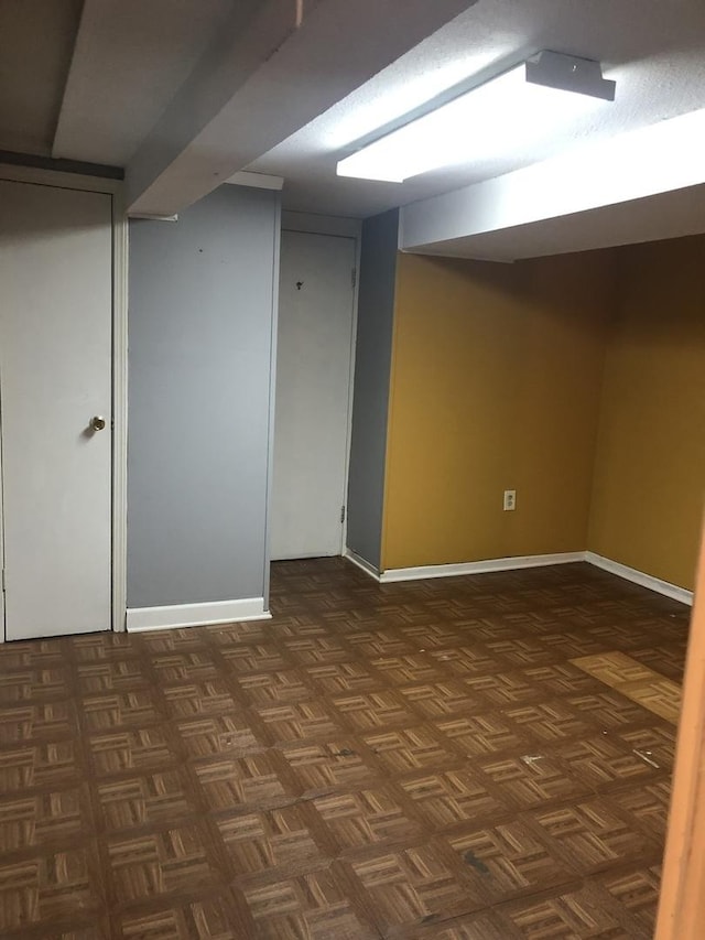 basement with dark parquet flooring