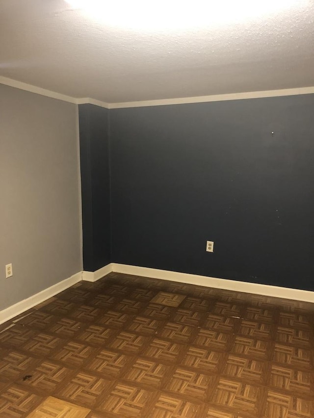 unfurnished room with crown molding and dark parquet floors