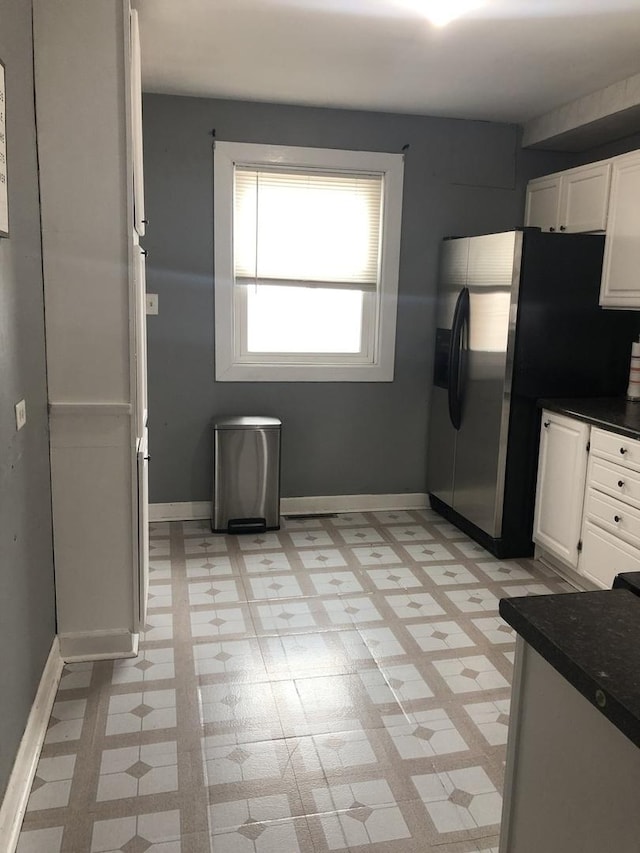 kitchen with white cabinets and stainless steel refrigerator with ice dispenser