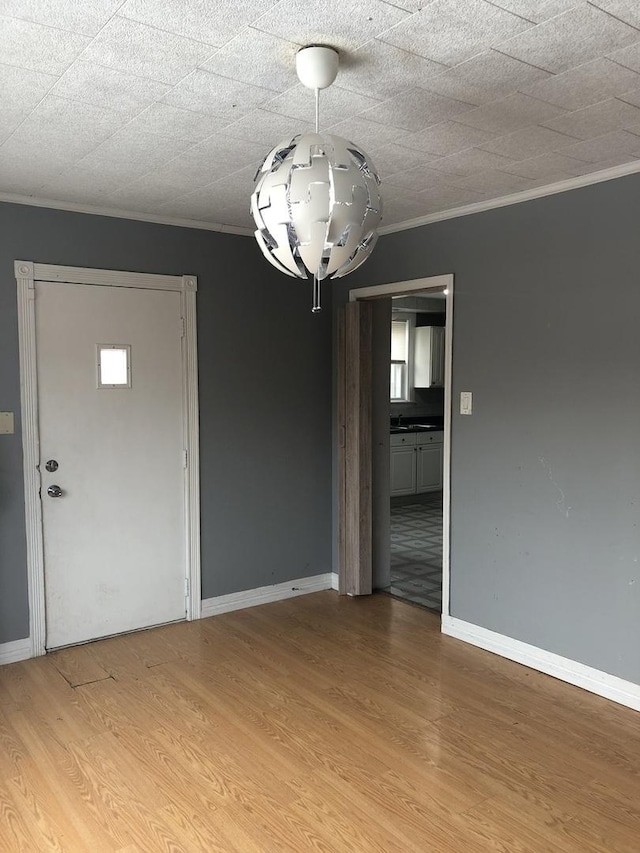 interior space featuring hardwood / wood-style flooring and ornamental molding