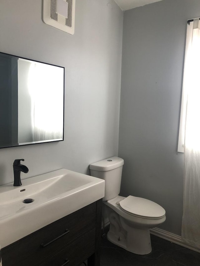 bathroom featuring tile patterned floors, vanity, and toilet