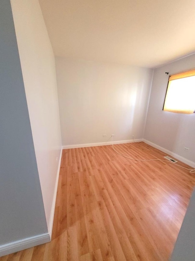 empty room with light hardwood / wood-style flooring