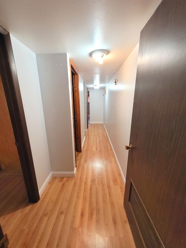 hall with light hardwood / wood-style flooring