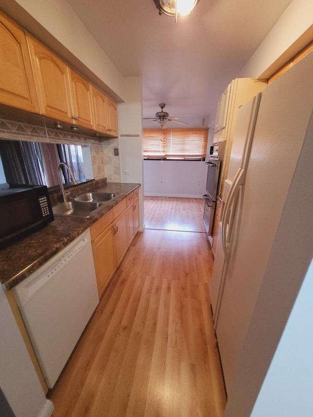 kitchen with ceiling fan, sink, tasteful backsplash, white appliances, and light wood-type flooring