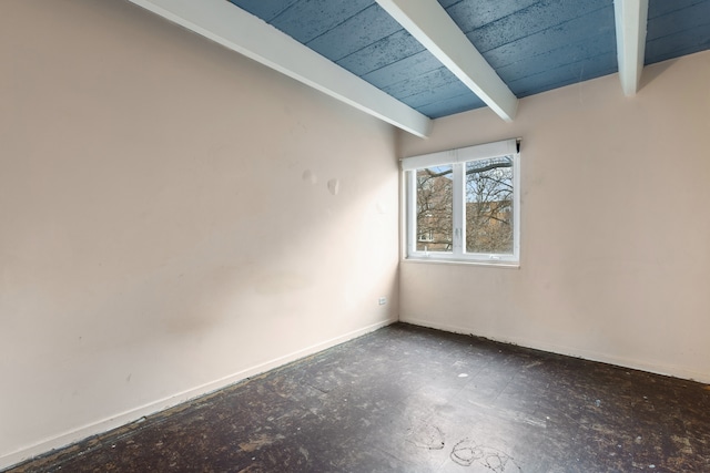 empty room featuring beam ceiling and wood ceiling