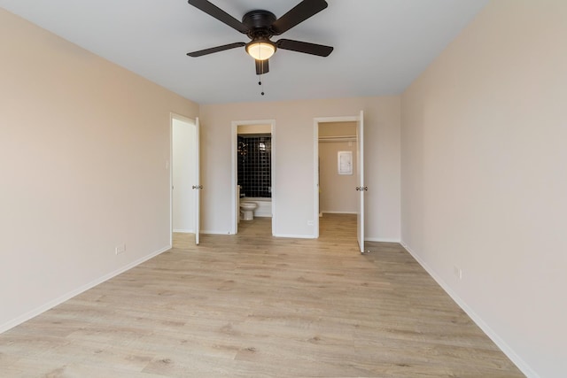 empty room with ceiling fan and light hardwood / wood-style floors