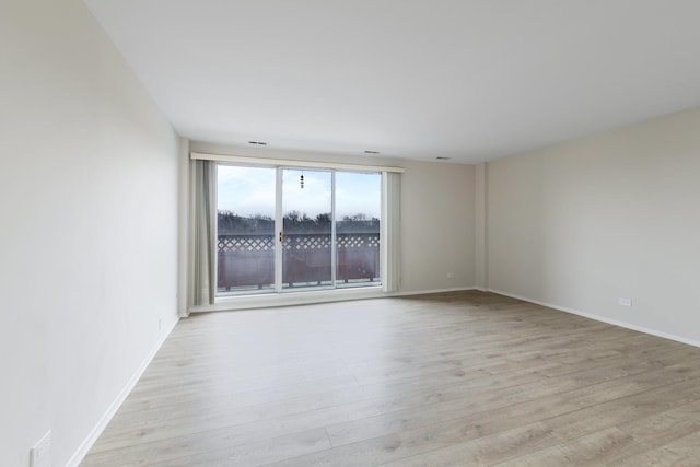 unfurnished room with light hardwood / wood-style flooring