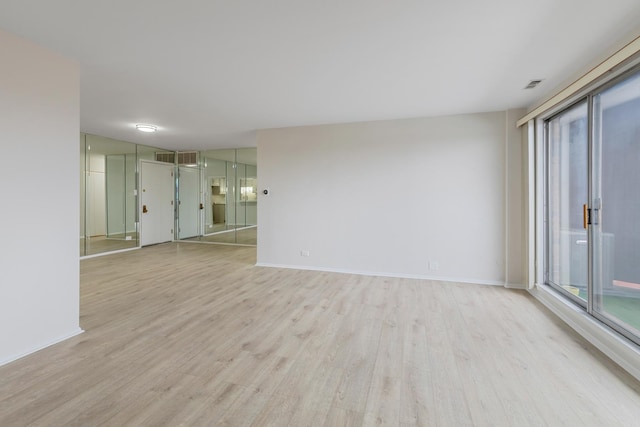 unfurnished room with light wood-type flooring