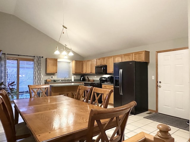 dining area featuring sink, light tile patterned floors, and high vaulted ceiling