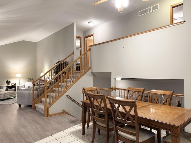 dining room featuring ceiling fan, light hardwood / wood-style flooring, and lofted ceiling