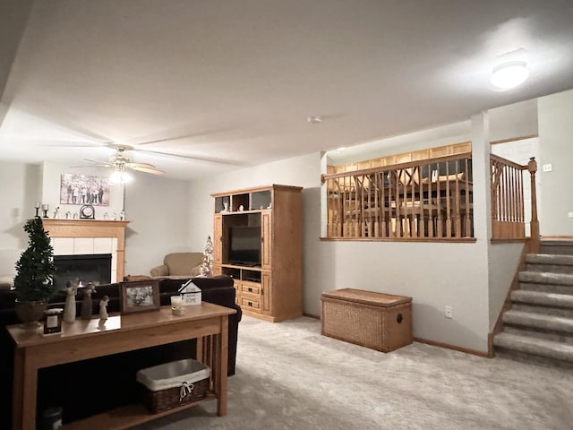 carpeted office with a tile fireplace and ceiling fan