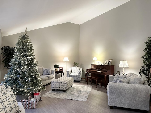 living room with light hardwood / wood-style floors and lofted ceiling