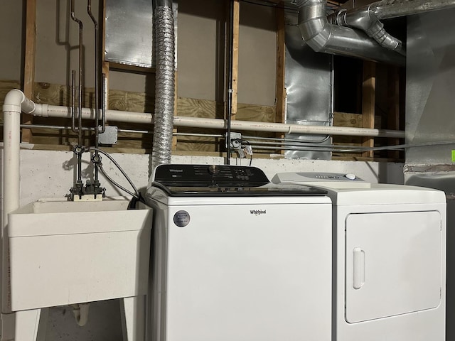 laundry area with sink and washing machine and clothes dryer