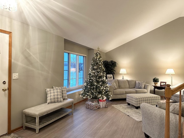 living room featuring a water view, lofted ceiling, and hardwood / wood-style flooring