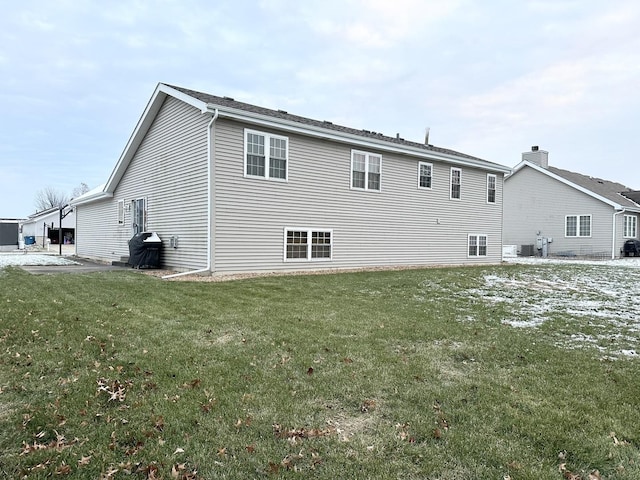 rear view of house featuring a yard