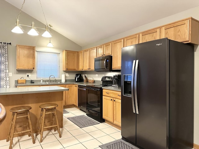 kitchen with lofted ceiling, black appliances, a kitchen breakfast bar, sink, and decorative light fixtures