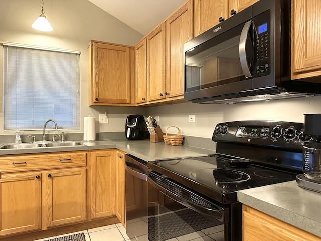 kitchen featuring sink, vaulted ceiling, light tile patterned floors, decorative light fixtures, and stainless steel appliances