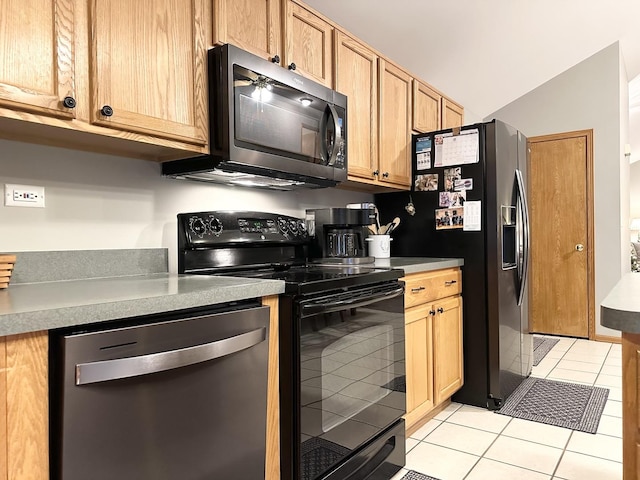 kitchen featuring lofted ceiling, light tile patterned floors, and appliances with stainless steel finishes