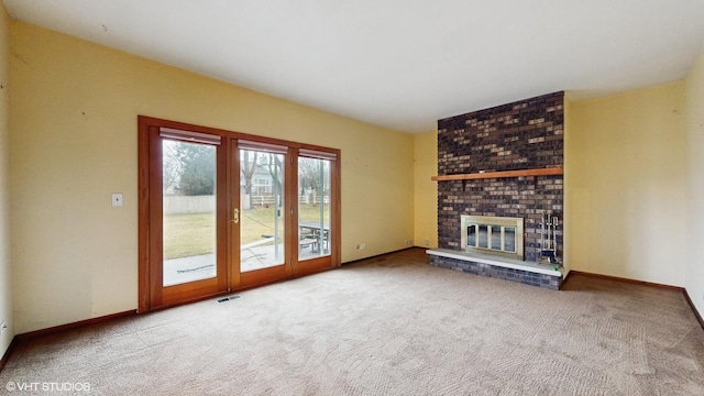 unfurnished living room with carpet floors and a fireplace