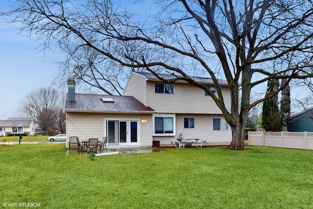 back of property featuring french doors and a yard