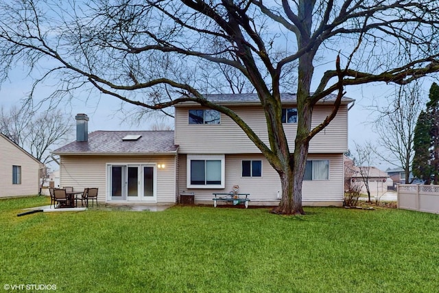 rear view of property featuring a patio area and a yard