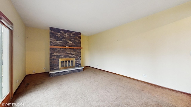 unfurnished living room with carpet and a fireplace