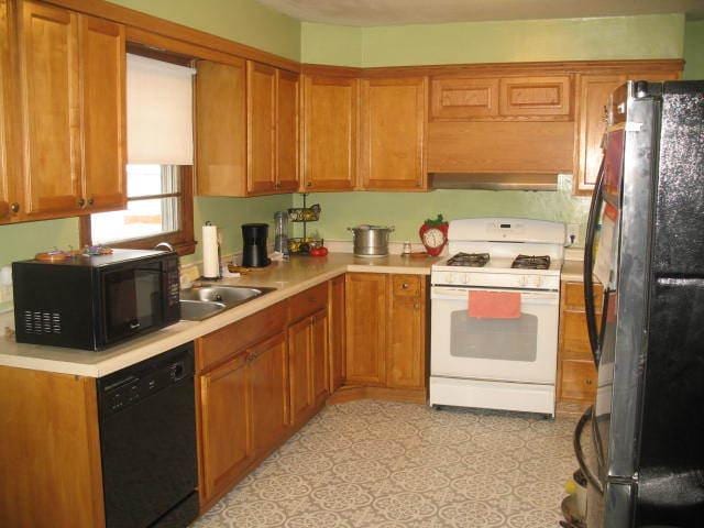 417 N Park Ave, Aurora, IL 60506 - kitchen with sink, range hood, and black appliances