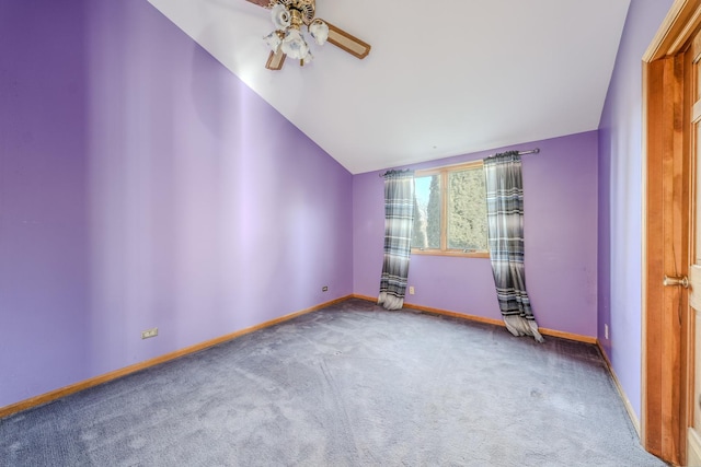 carpeted spare room with vaulted ceiling and ceiling fan