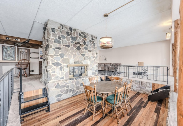 dining room featuring a fireplace and hardwood / wood-style floors