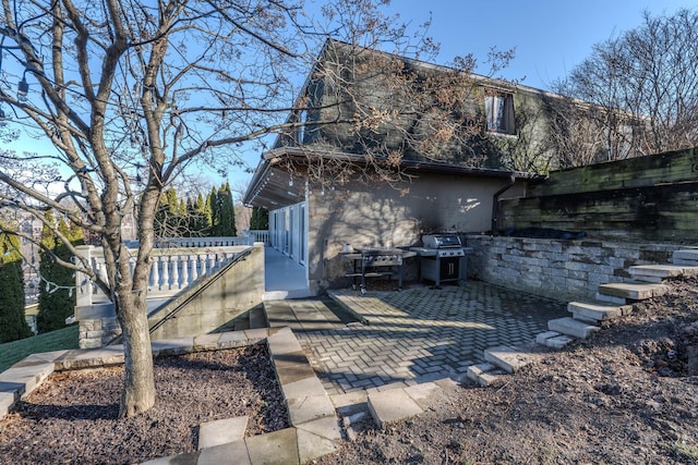 rear view of property featuring a patio area