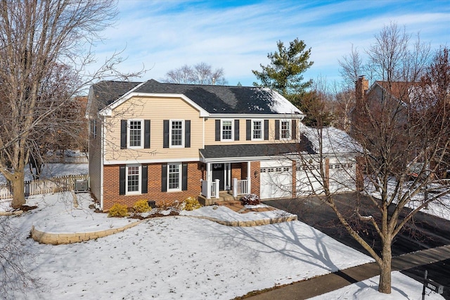 view of front of property with a garage and cooling unit