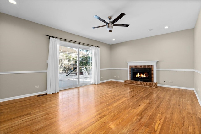 unfurnished living room with a fireplace, light hardwood / wood-style floors, and ceiling fan