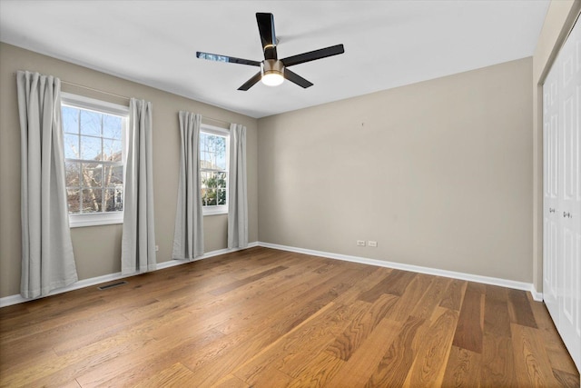 unfurnished bedroom with hardwood / wood-style floors and ceiling fan