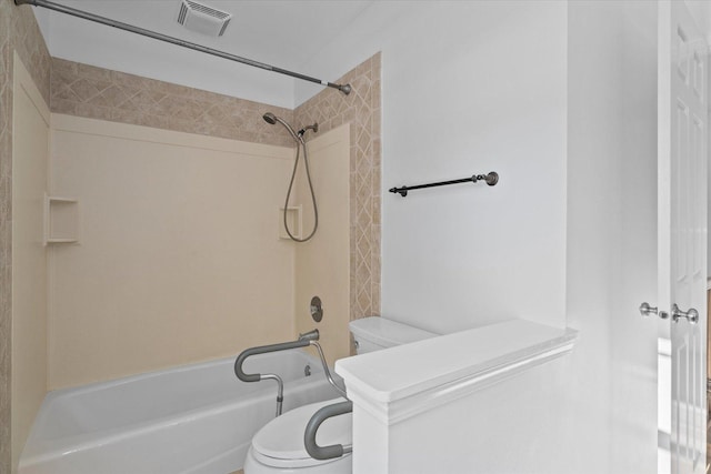 bathroom featuring bathtub / shower combination and toilet