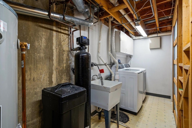 clothes washing area featuring sink and washer and dryer