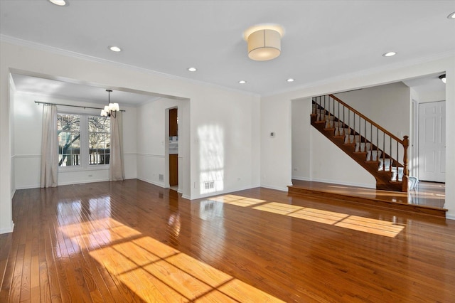 interior space featuring a notable chandelier, wood-type flooring, and ornamental molding