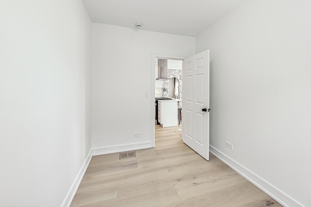 spare room featuring light hardwood / wood-style floors