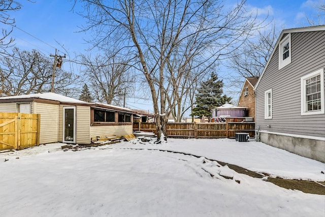 yard covered in snow with central AC unit