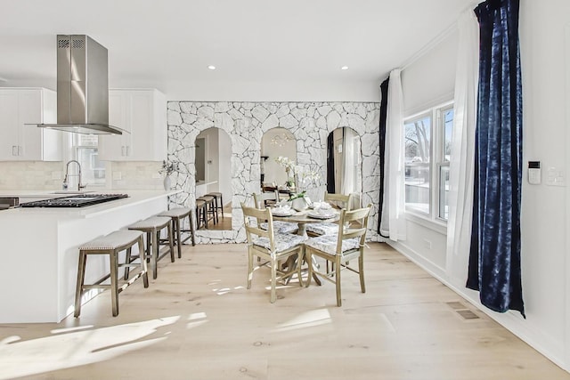 dining room with sink and light hardwood / wood-style flooring