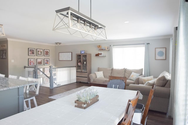 dining room with crown molding and dark wood-type flooring