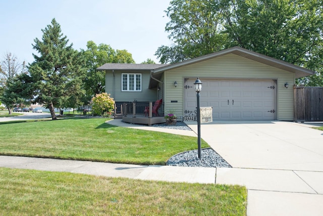 view of front of property featuring a garage and a front lawn