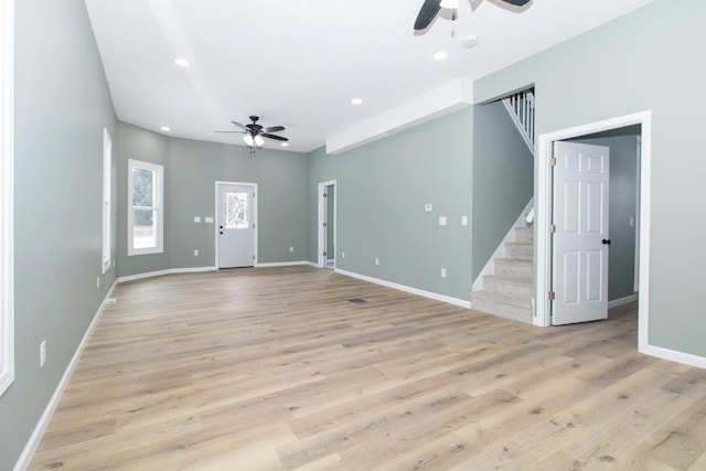 unfurnished living room featuring light hardwood / wood-style flooring and ceiling fan