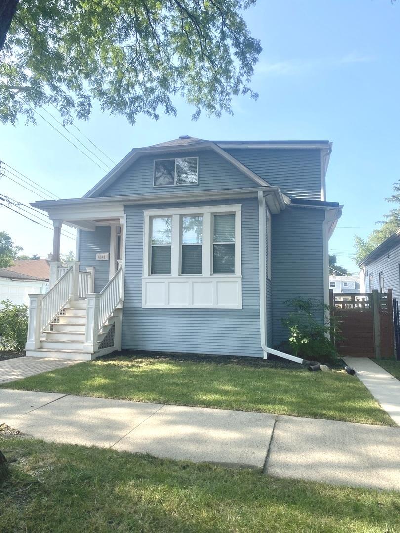 bungalow-style house featuring a front yard