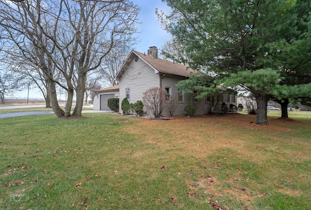 view of home's exterior featuring a lawn and a garage